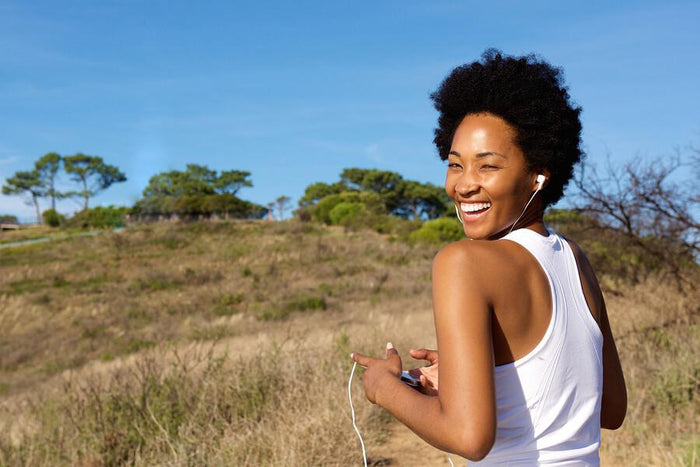 women exercising outside and listening to music