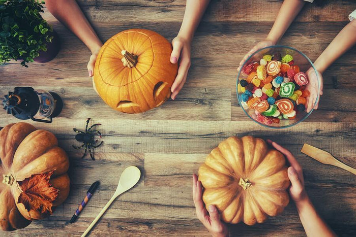 two people comparing their pumpkins